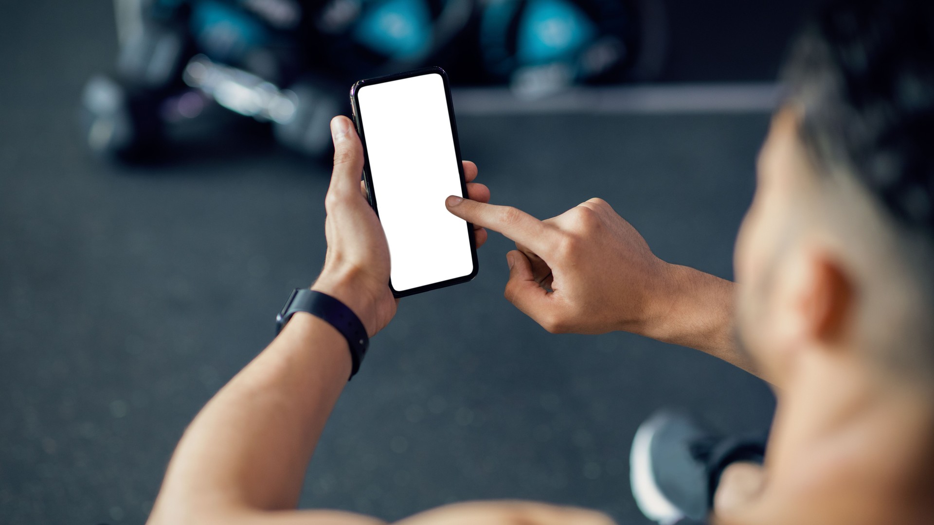 Unrecognizable Male Using Cellphone With White Screen At Gym, Mockup